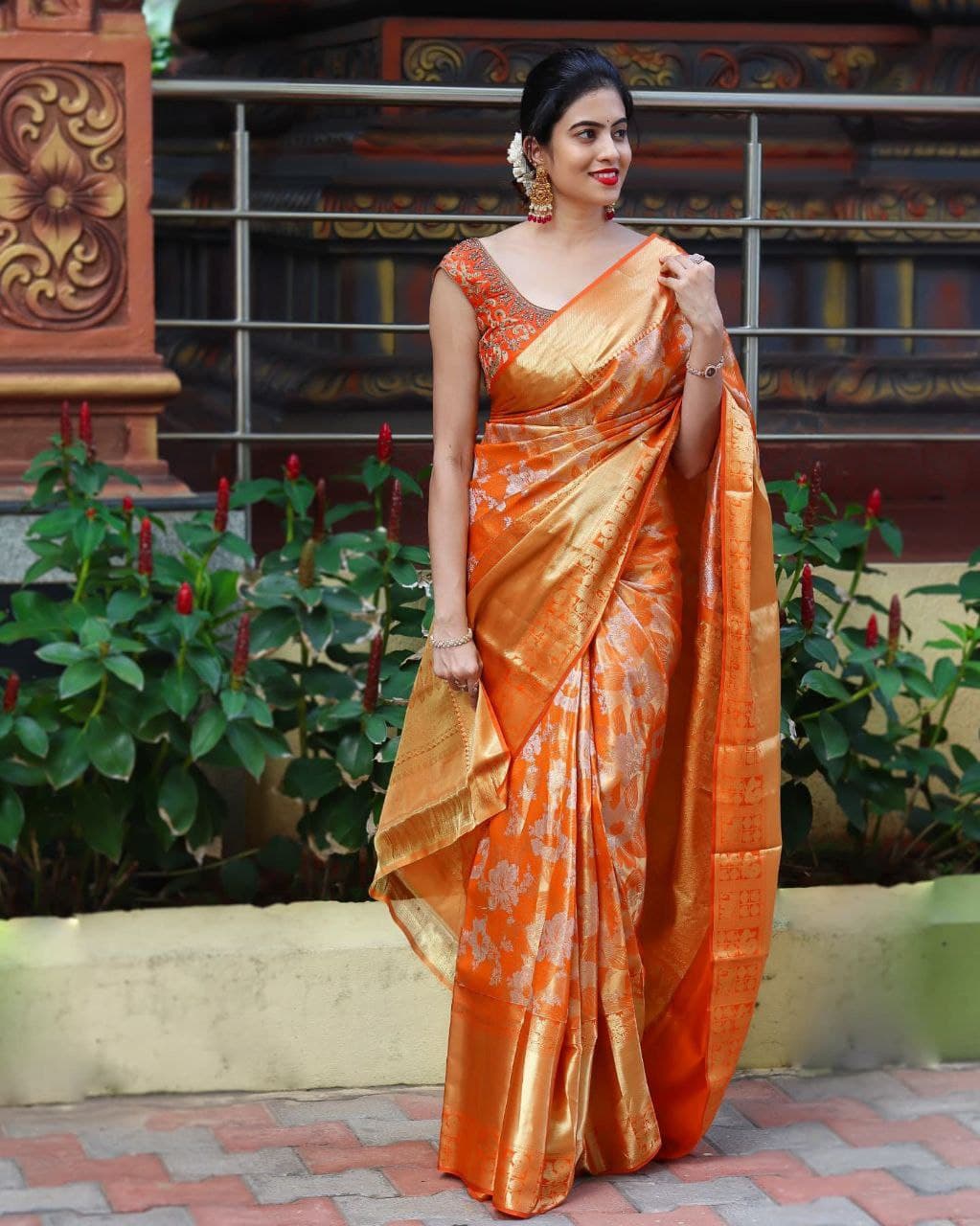 Vibrant Orange Silk Saree with Detailed Designs and Matching Border