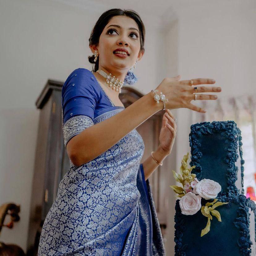 Graceful Elegance: Woman in Blue Silk Saree with Silver Detailing