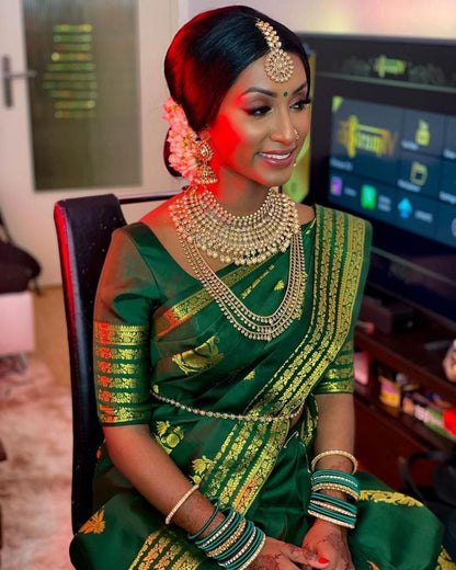 Elegant Contrast: Green Kanjivaram Saree with Pink Highlights and Peacock Motifs