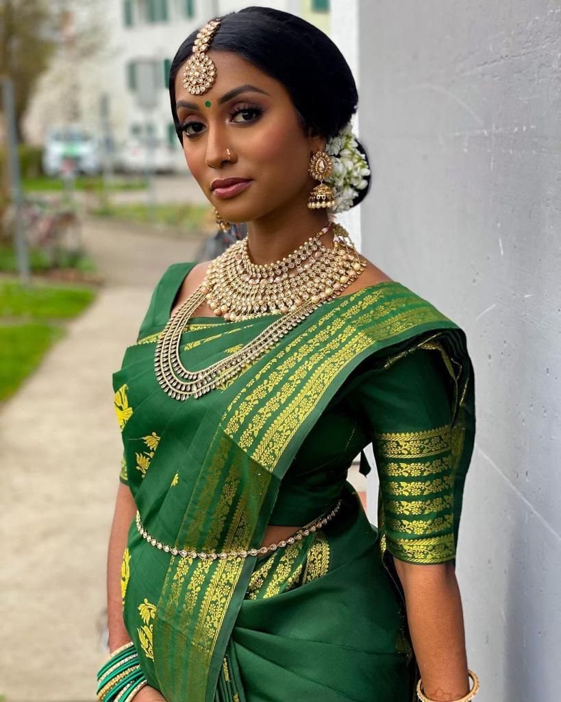 Elegant Contrast: Green Kanjivaram Saree with Pink Highlights and Peacock Motifs